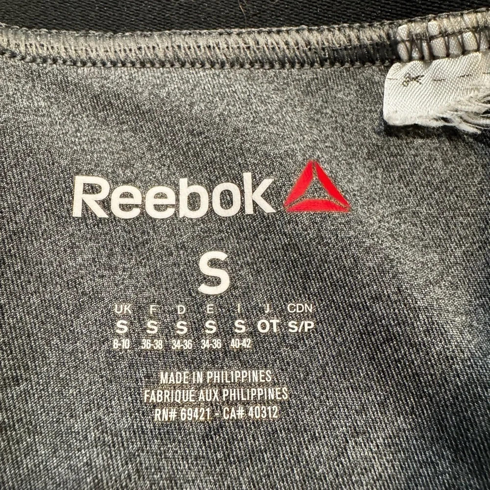 Reebok charcoal gray athletic leggings, mesh patterned detailing on side, S.